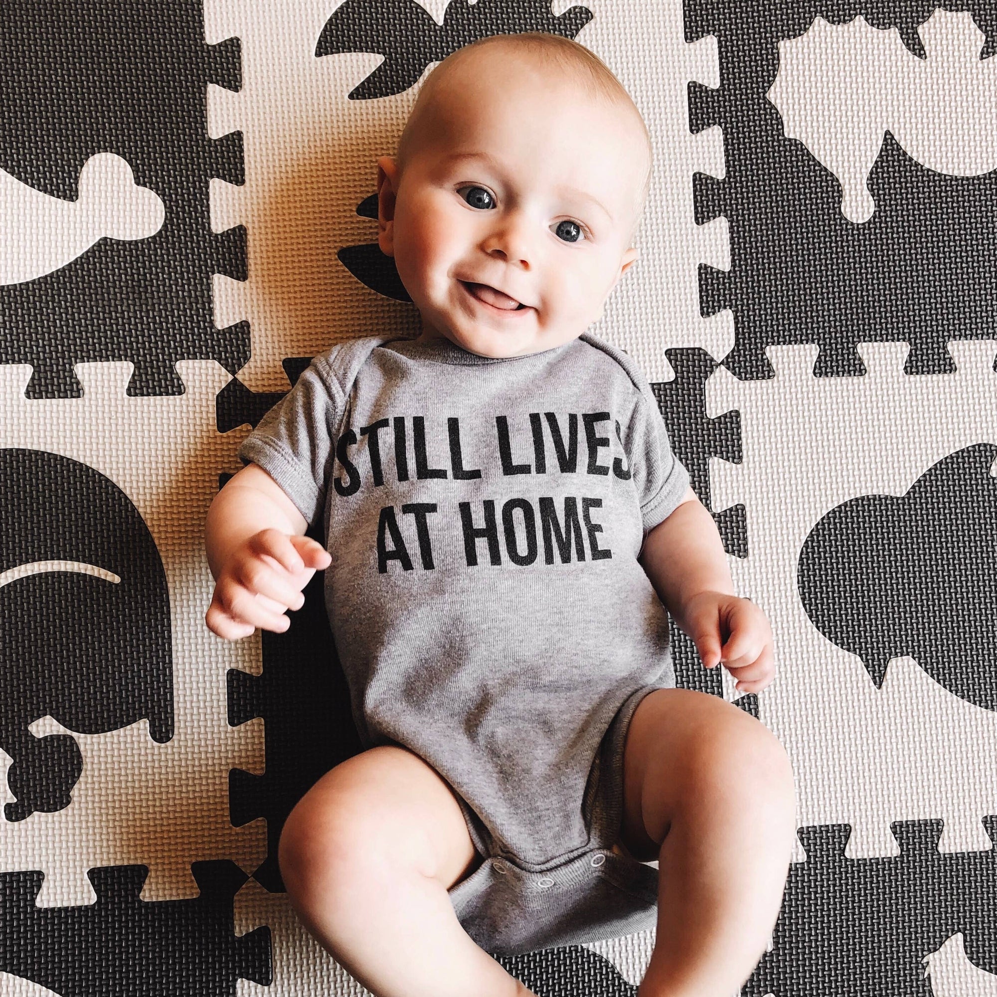 Still Lives at Home Onesie